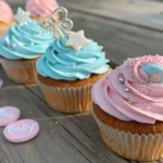 Gender reveal cupcakes decorated with pink and blue frosting