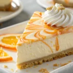 Best creamsicle cheesecake with orange swirls and whipped cream